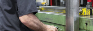 A custom metal stamping manufacturer using a stamping press