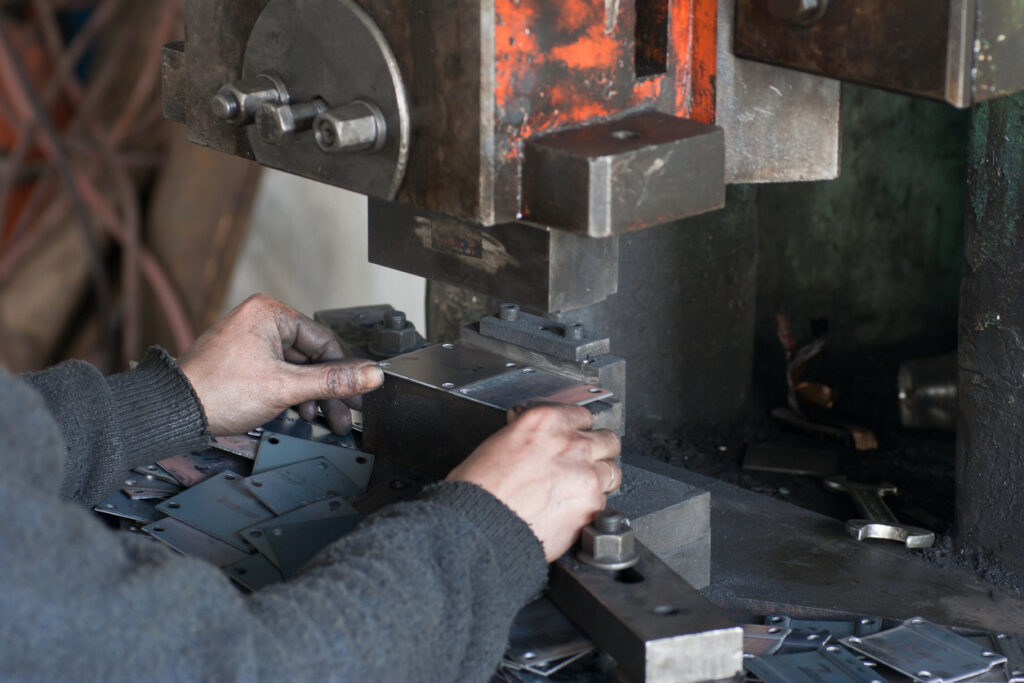 A closeup of progressive metal stamping manufacturers working